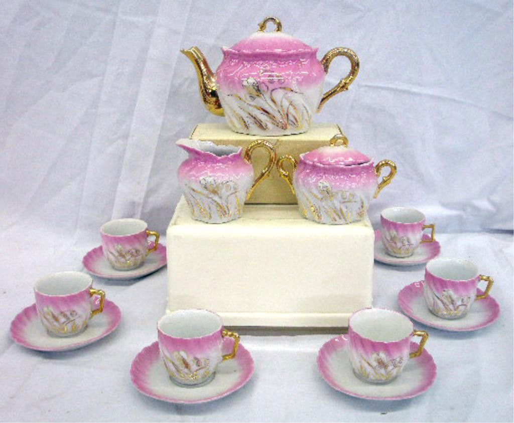 Antique German Porcelain Child's Tea Set: Early 20th c. German porcelain fifteen piece child's tea set. Condition: Very good with crack on 1 cup.