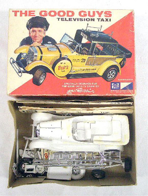 1968 The Good Guys Taxi Model Kit: 1968 Model Products Corporation The Good Guys Television Taxi model kit with original box. Condition: Partially assembled, may have pieces missing, glue residue on taxi, box has wear & tearing.