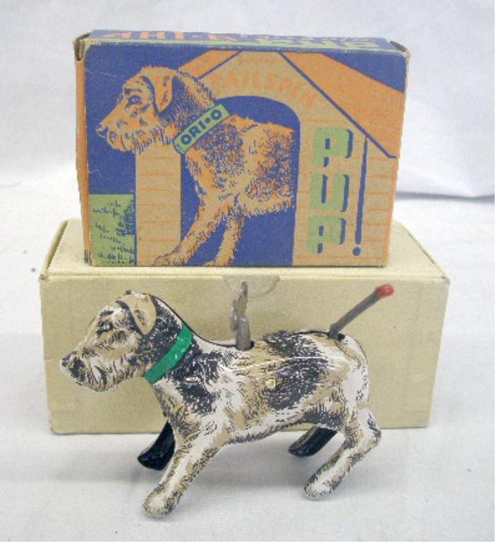1950's Tin Key Wind Tailspin Pup: 1950's Orianna Metal Products, Inc. lithographed tin key wind Tailspin Pup with original box. Condition: Works, very good with minor wear, box has minor wear.