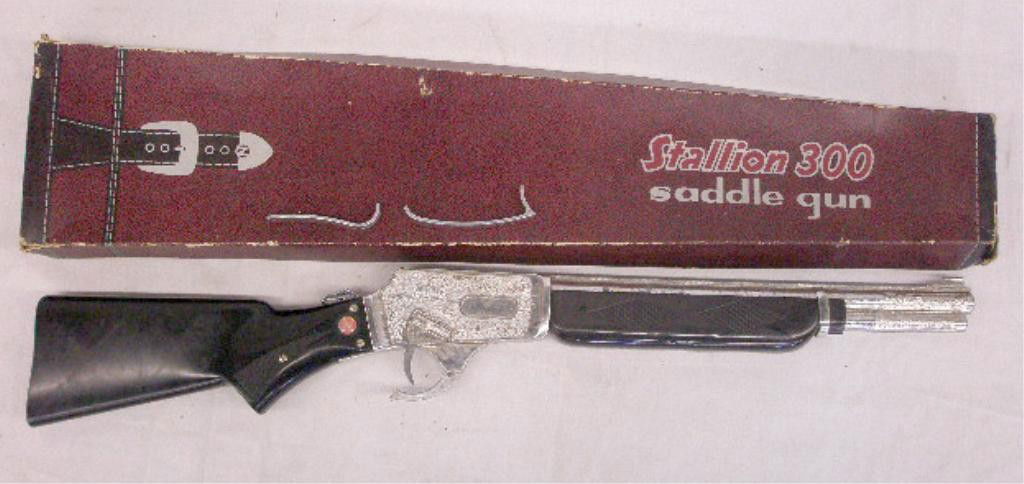 1950's Nichols Stallion 300 Toy Cap Rifle: 1950's Nichols Stallion 300 Saddle Gun toy cap rifle with original box. Condition: Grip is broken with detached pieces, overall condition of gun is very good with some wear, box has wear.