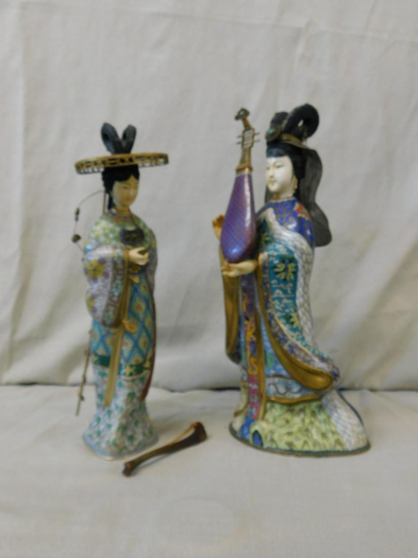 2 Chinese Cloisonne Figures: Two Chinese Cloisonne Figures, elaborately dressed standing female figures with gilt highlights and bone ? carved face and hands, each holding a musical instrument, 20th C, 14"h and 12 1/2"h. CONDITIO