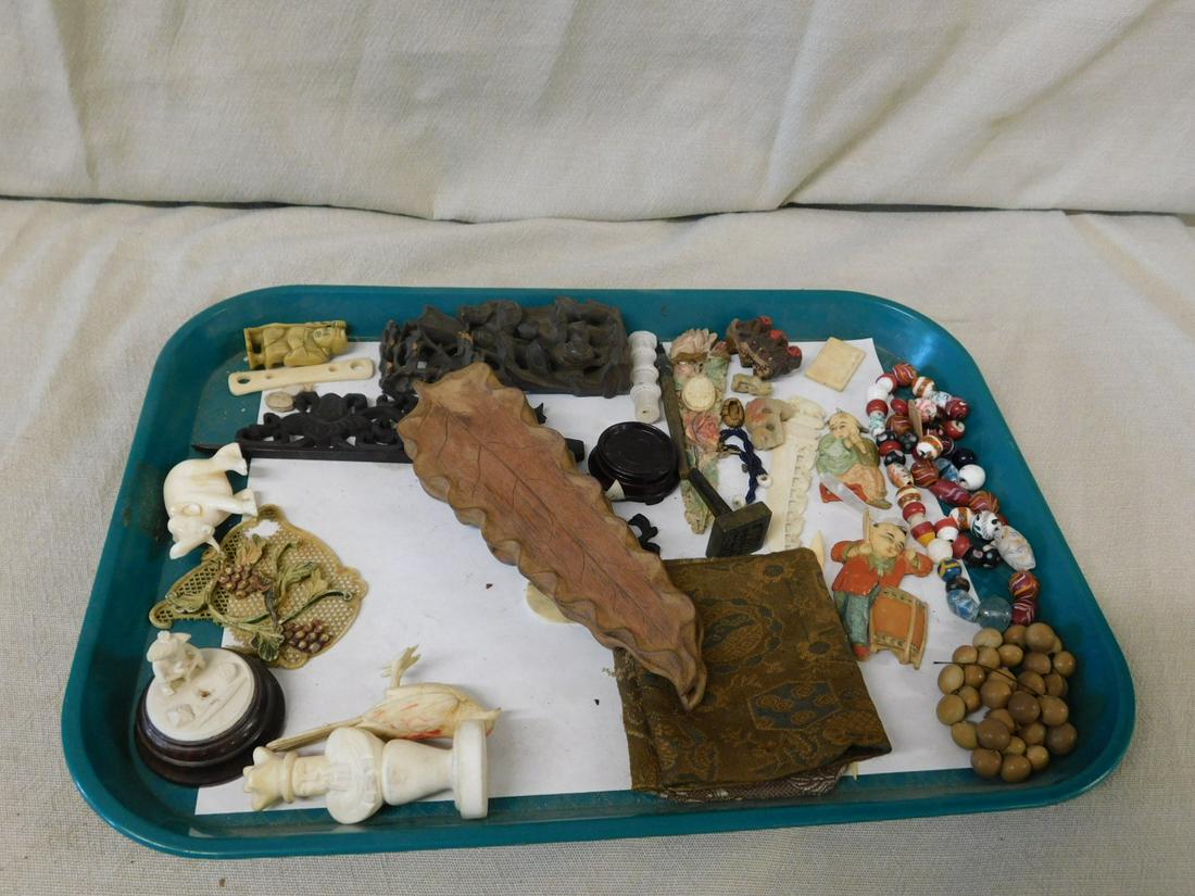 Oriental Carvings & Accessories: Oriental Carvings and Accessories, includes: carved bone figures, bronze seal, figural carved wood segment, beads, foot prints of Krishna amulets, wood stands, etc. CONDITION: Very good to poor.