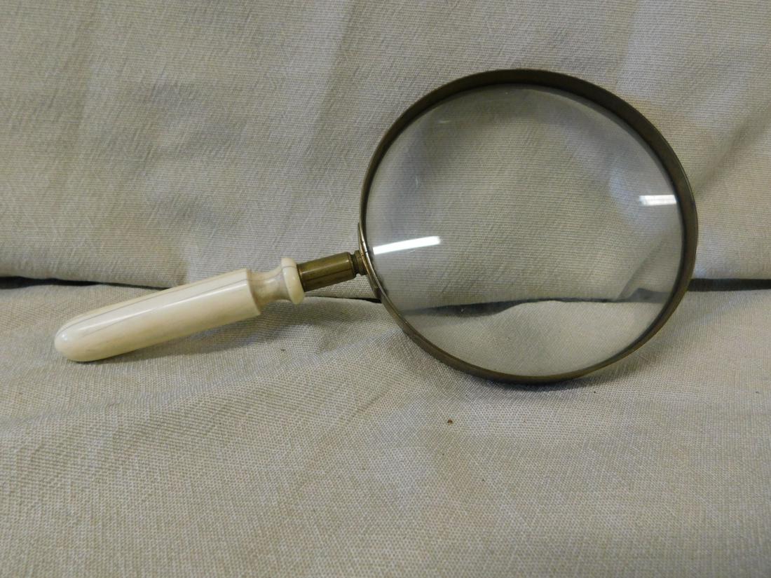 Antique Magnifying Glass: Antique magnifying glass, a 3 1/4" turned bone? shaft joins a brass bracket and frame with a 4 1/2" magnifying glass. L 8 3/4", 19th/20th c. CONDITION: Used, expansion hair loss bone handle, tarnished