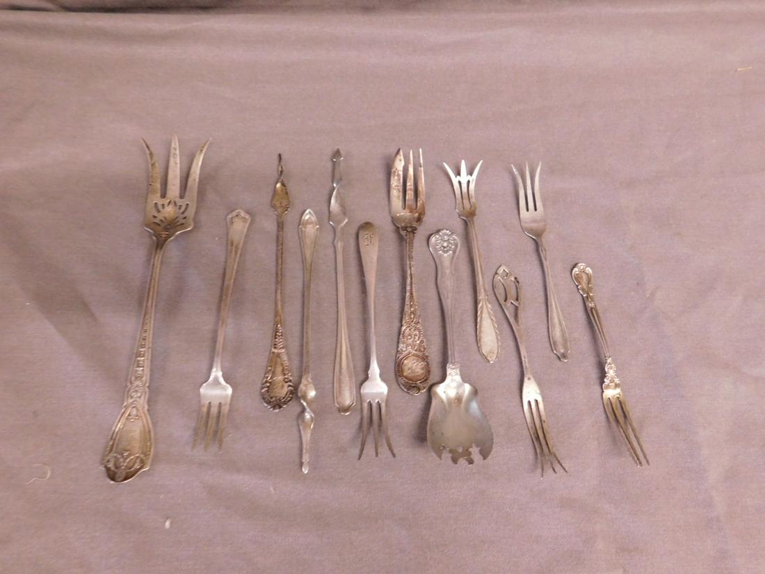 12 Sterling Forks & Butter Picks: Twelve Sterling Forks and Butter Picks by Manchester, Caldwell, Wallace and others, includes: three butter picks, 8" serving fork, dessert and seafood forks, from 4 3/4" to 8", 6.57 ozts TW. CONDITION