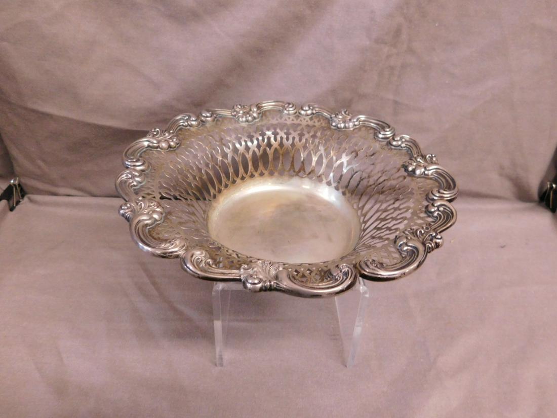 Sterling Silver Fruit Bowl: Sterling Silver Fruit Bowl by G.W. Russell, No. 2073, overall reticulated with a heavy elaborate scroll work border, early 20th C. Diameter 9 1/2", Hgt 2 1/2", 9.8ozt. CONDITION: Very fine, light tarn