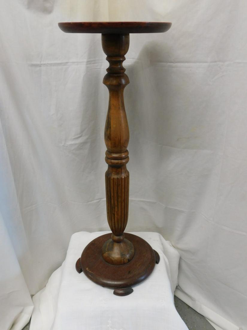 Mahogany Pedestal: Mahogany Pedestal, rib and urn turned column on circular footed base, early 20th C, 12"d, 34"h. CONDITION: Good, used cond., scratches to top surface.