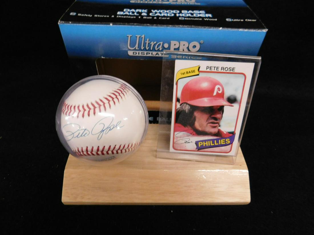 Pete Rose Signed Baseball w/Card: Pete Rose Signed Baseball w/Card, signed on sweet spot of National Baseball Hall of Fame ball in round case on wood stand with Pete Rose Burge King 1980 Phillies baseball card. We Do Not Guarantee aut