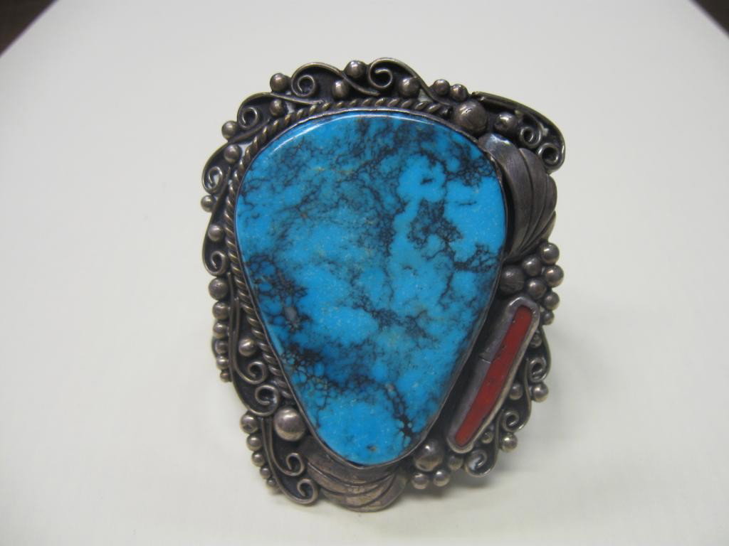 Native American Silver Bracelet: Native American silver bracelet, Old Pawn, large exquisite turquoise with coral strip, Navajo design. 2 1/2" across front, 3" height, 2 1/4" inside diameter, signed chief on one side of back unable to