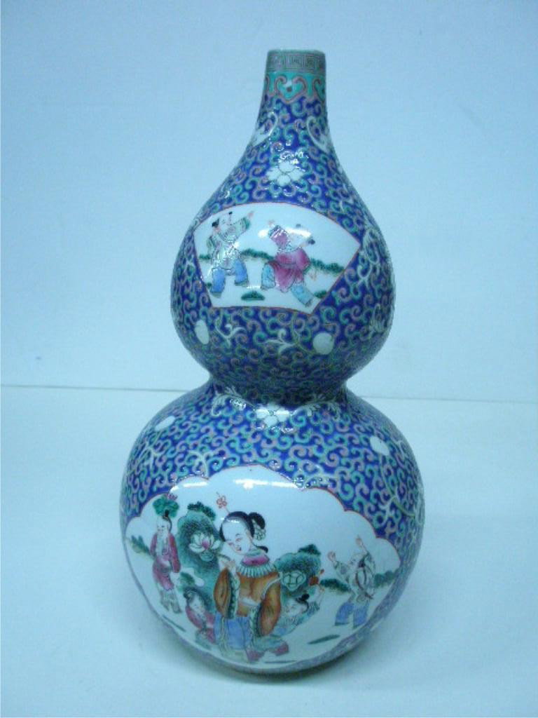 Chinese Porcelain Famille Bleu Double Gourd Vase: Chinese porcelain famille bleu double gourd vase, overall scroll field around four life scene painted panels, signed on base, 19th C., height= 16". [with low, square ebonized wood stand]. Condition: N