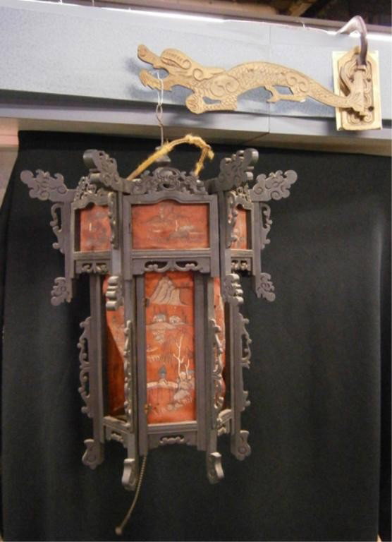Chinese Hanging Lantern: Chinese hanging lantern ebonized wood with painted silk panels, suspended by a dragon form brass swivel bracket, early 20th c. lantern hgt 16". Condition: Rips to some of the silk panels, electrified.