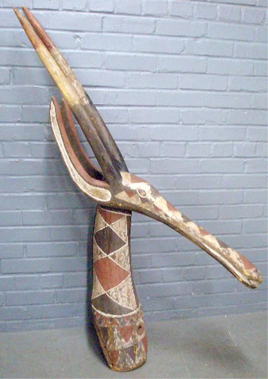 African Gazelle Mask: Early 20th c. African Gazelle mask, polychromed soft wood, hgt 57". Condition: 2 shrinkage cracks at back base of neck, areas of paint loss.