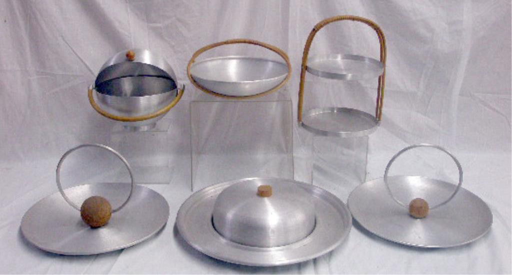 Russel Wright Spun Aluminum Serving Pieces: Six 1930's Russel Wright Spun Aluminum serving pieces, 13 1/2" two tier tray, 9" bun warmer, two 13" serving trays, 16 1/4" cheese server & 5 1/2" x 11" fruit basket. CONDITION: All have some form of