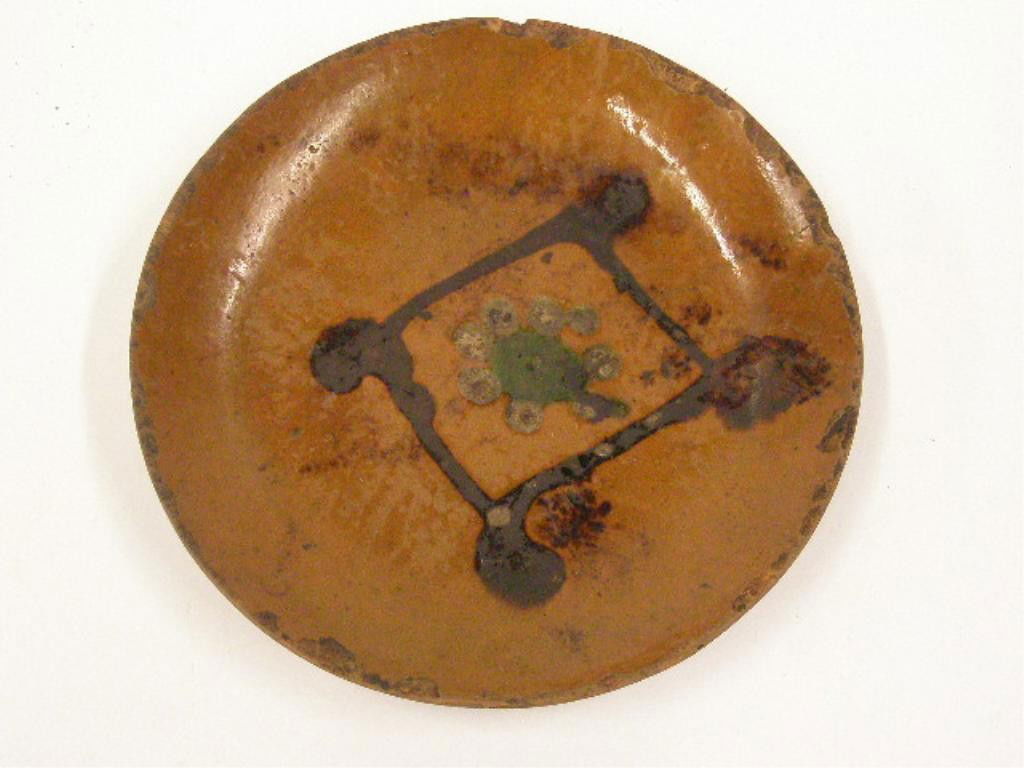 19th c. Redware Brown Slip Decorated Plate: 19th c. Redware 7 3/4" plate with brown slip diamond decoration. CONDITION: Significant loss & wear along rim, crazing, wear & loss in center, wear on back.