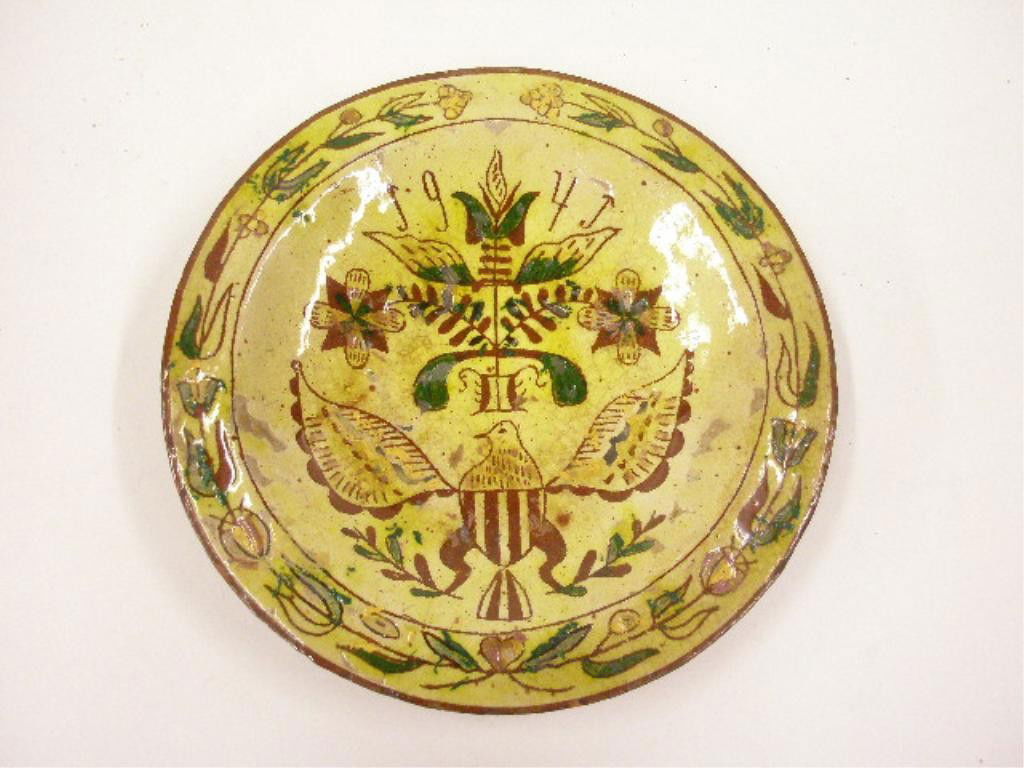 1940's Redware Slip Decorated Plate: 1940's Redware 8 1/2" plate with brown, yellow & green slip American Eagle & floral decoration. CONDITION: Small chips along rim, crazing, wear & loss in center, wear on back.