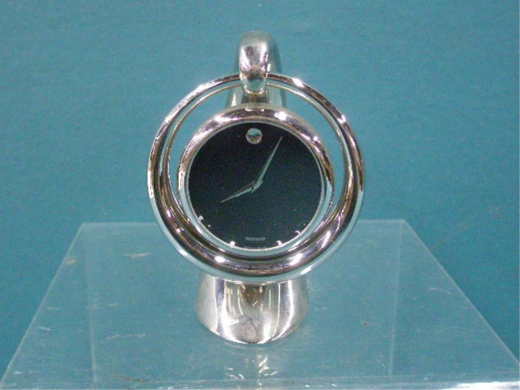 Movado Hanging Desk Clock: Movado silver toned metal 3 3/4" x 2 1/2" x 2 1/2" hanging desk clock. CONDITION: Not working, very good with minor wear.