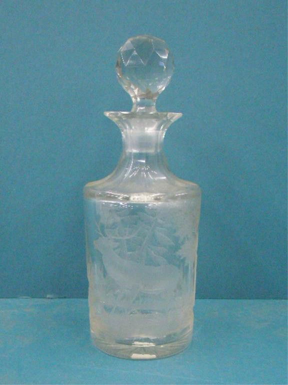 19th c. Bohemian Glass Bottle: Mid to late 19th c. Bohemian crystal glass 9" bottle with stopper, intaglio cut stag in forest setting design. CONDITION: Chips along top bottle rim & stopper base, scratches & wear on base.
