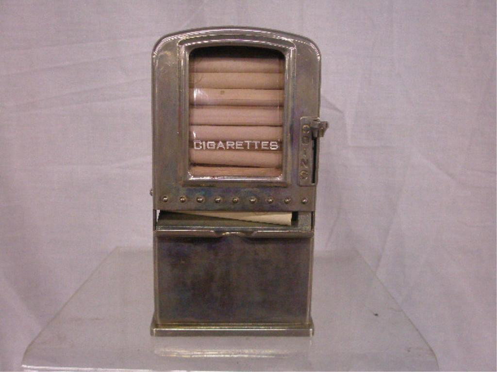 1940's Coin Operated Cigarette Machine: 1940's Napco Inc. 5 cent coin operated chrome steel 6 1/4" x 3 3/8" x 1 3/4" counter top cigarette dispensing machine with original Lucky Strike era cigarettes, model of a large floor model National C