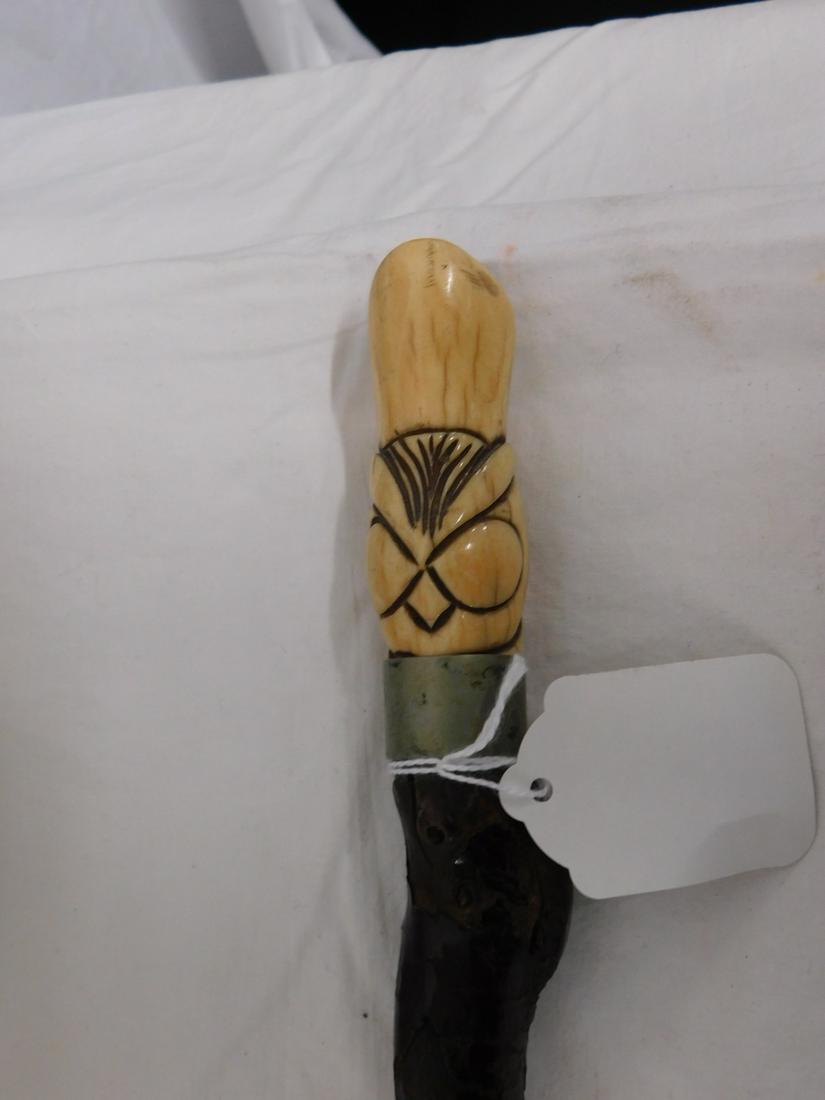 Bone Fan & Scroll Design Handle Cane: Bone Handle Cane: Handle: Hoof shaped bone with incised fan and scroll design, 3"l. Collar: Nickle plated brass. Shaft: Bark covered knobby cherry wood. Length: 34". Vintage: Early 20th C. [7104] VERY