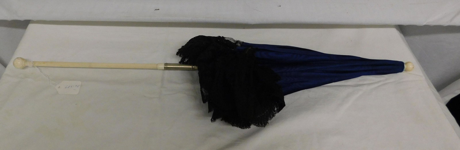 Victorian Folding Parasol: Victorian Folding Parasol, bone ball top shaft and ribs, folding handle with nickle plated locking tube, blue cloth canopy with black lace work border,white silk inner canopy; bone ball end tip; late 