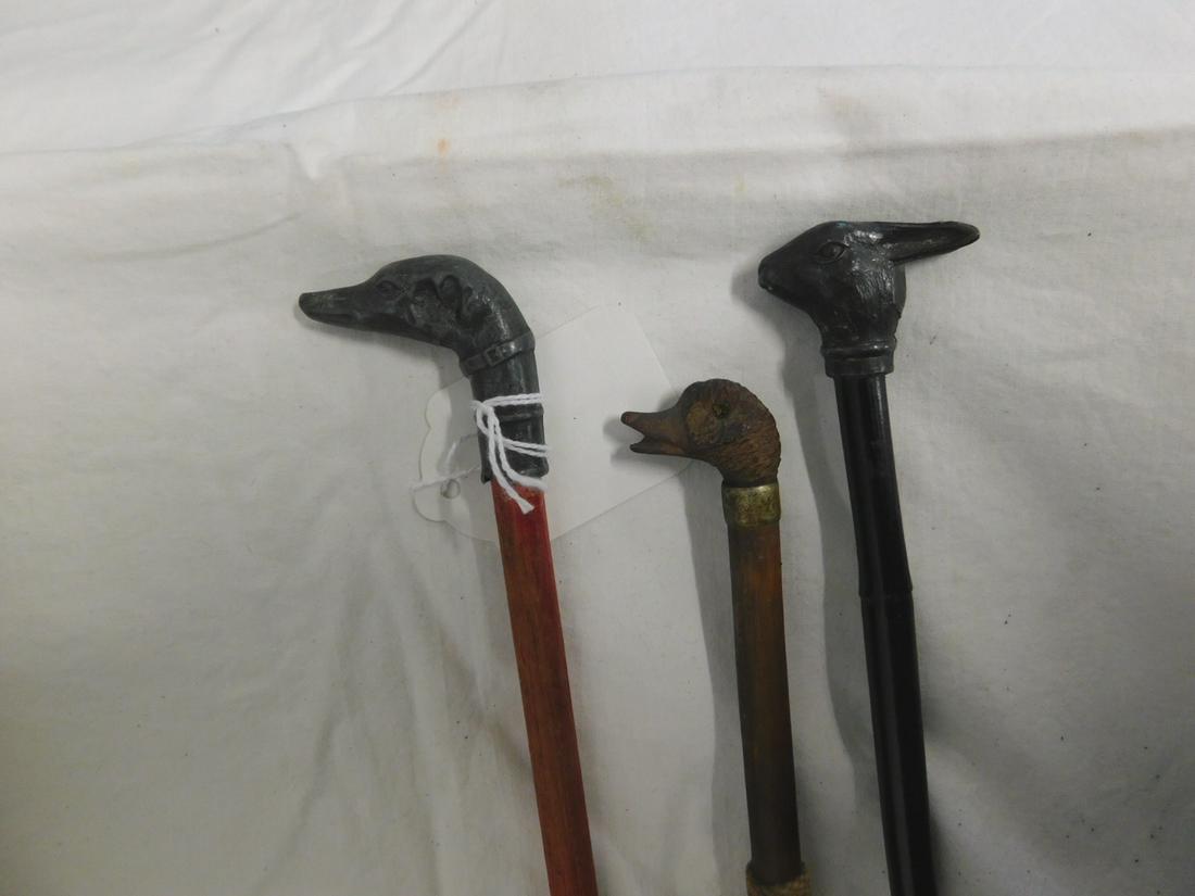 3 Animal Head Canes: Three Animal Head Canes, Spelter metal rabbit head on black bamboo shaft, 35"l, carved wood duck head with metal collar, bamboo shaft and metal ferrule, 29"l, and a Spelter metal Greyhound dog head on