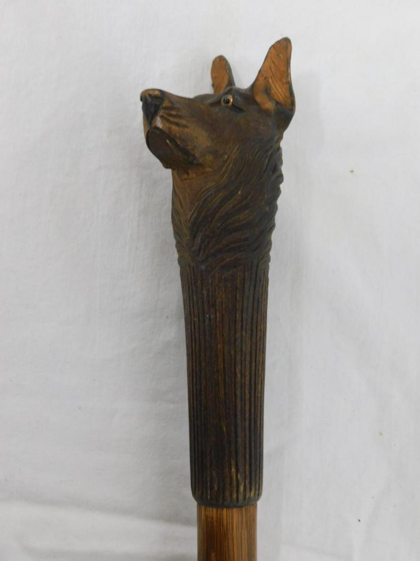 Dog Head Cane: Dog Head Cane. Handle: Black Forrest type walnut carved dog head with glass eyes and pointed ears, 5 3/4"l. Collar: None. Shaft: Smoothed bamboo. Ferrule: Steel and iron. Length: 37 1/2". Vintage: Ear