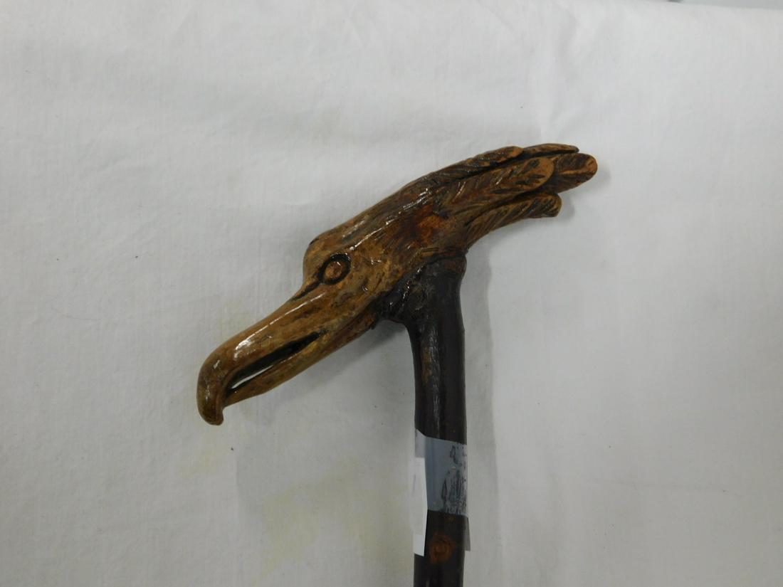 Folk Art Cane: Folk Art Cane. Handle: Bird head carved wood handle, 5 3/8"l. Collar: None. Shaft: Bark covered knobby cherry. Ferrule: Brass. Length: 33". Vintage: Early to mid 20th C.[18] CONDITION: Used, areas of