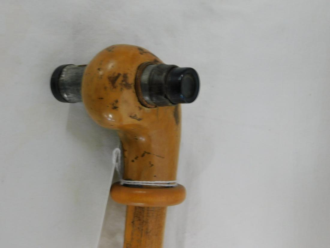 Telescope Cane: Telescope Cane. Handle: Knob top with single pull tin telescope having a small compass attached, 2 7/8"h, 3 1/2"l. Collar: Wood ring. Shaft: Light stained hardwood. Ferrule: Metal. Length: 36 1/4". Vi