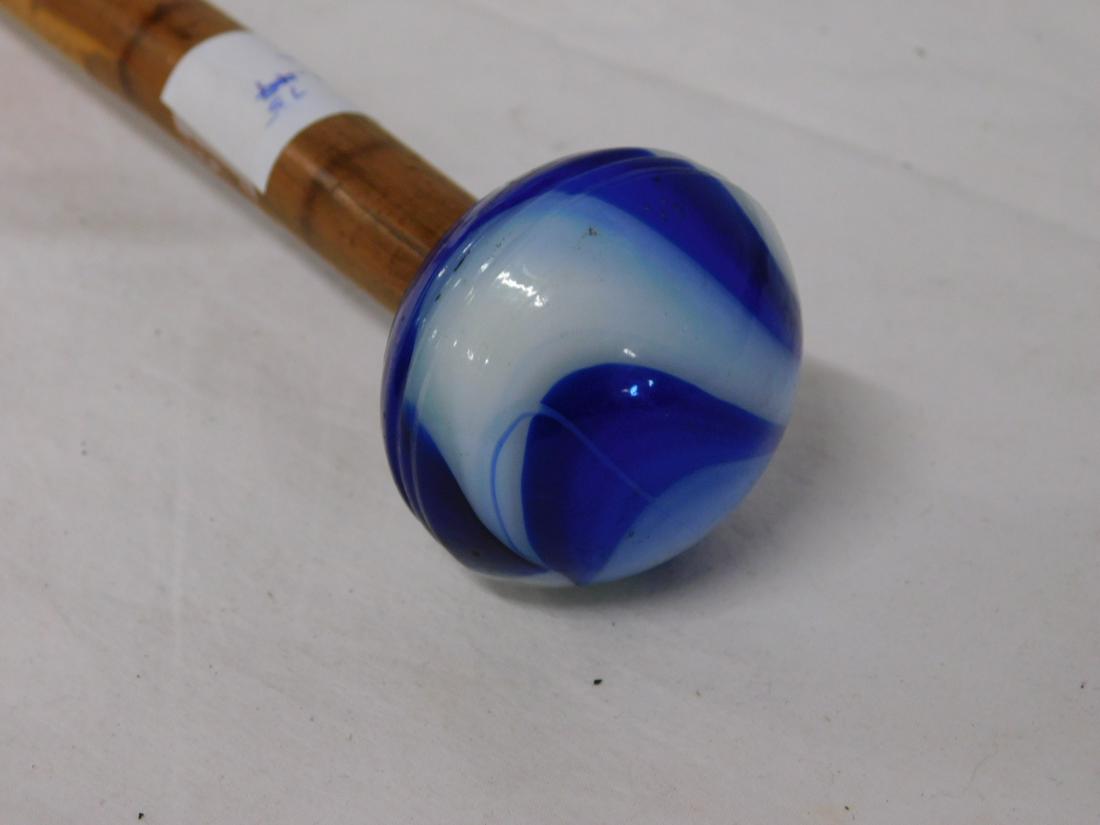 Cobalt Swirl Glass Knob Handle Cane: Glass Knob Handle Cane: Handle: Cobalt and opalescent swirl glass compressed ball handle, 2"d. Shaft: Bamboo. Ferrule: None. Length: 34". Vintage: Early to mid 20th C.[75] CONDITION: Very good.