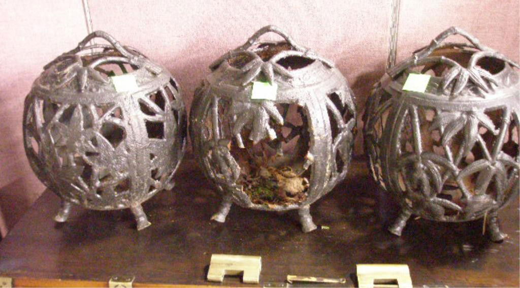 Three Chinese Cast Iron Lanterns: Three Chinese cast iron lanterns, in melon form reticulated in bamboo / leaf design, four feet, 19th / 20th C., h 11 1/2", diam 9 3/4".