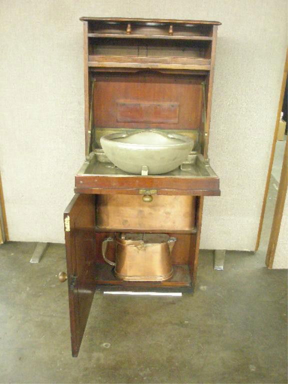 Antique Ship's Washstand: Antique Ship's Washstand, mahogany, fitted open bottle stand and shelf above paneled fall-front containing original metal wash basin attached to a metal liner with drop spout, the cabinet door below c