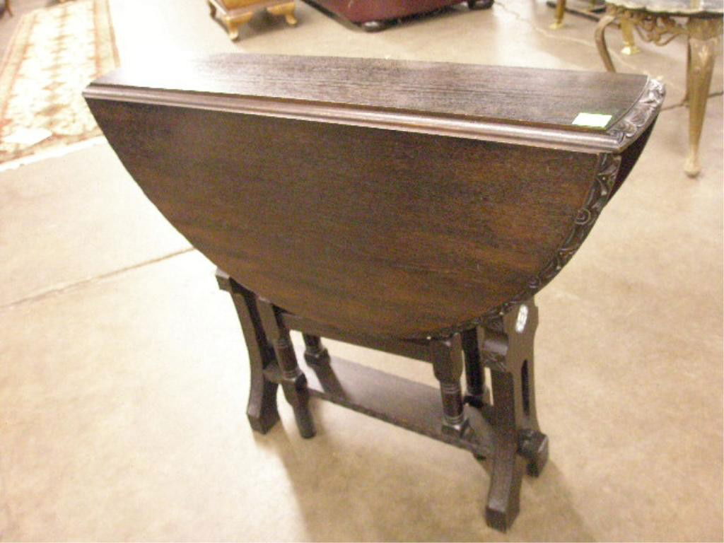 Arts & Crafts Gate Leg Tea Table: Arts & Crafts oak gate leg tea table with carved top edge & legs, Minton-type single diamond tile inset on each leg panel. Panel. Probably American c. 1900. 27" h 33" diameter (open); 7 1/2" diameter