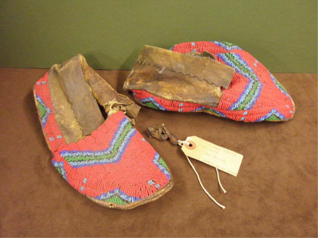 Early 20th c. Sioux Beaded Moccasins: Pair of c. 1900 Native American Indian Sioux tribe, rawhide & beaded 10" moccasins.