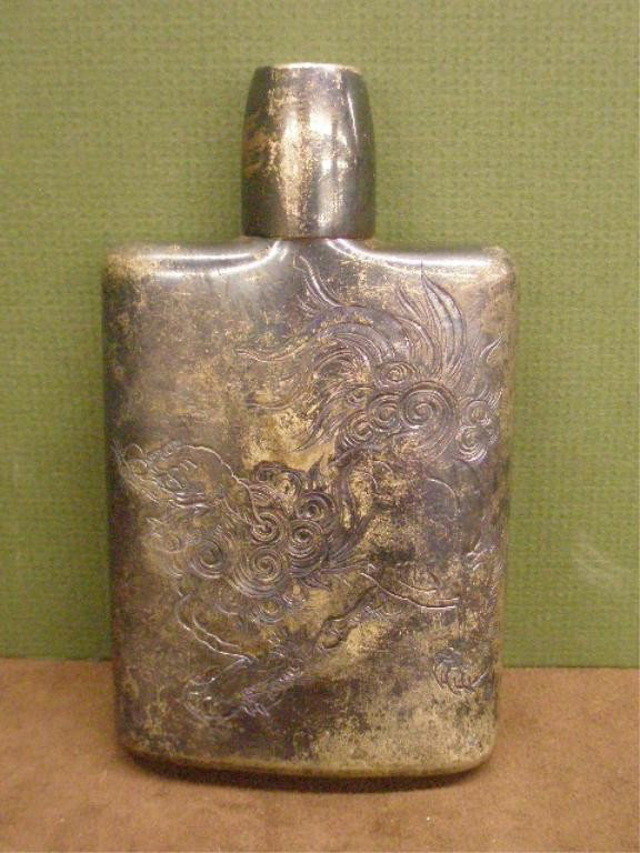Antique Sterling Silver Flask: Antique sterling silver 5 1/2" x 3" pocket flask, engraved foo dog design on front & hammered back, 5.49 troy ounces.