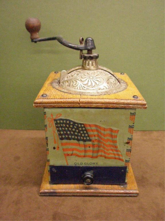 Bronson Walton Old Glory Coffee Grinder: Early 20th c. The Bronson Walton Co., Cleveland Ohio, lithographed tin, cast iron, & oak "Old Glory" 10 3/4" x 5 3/4" coffee grinder.