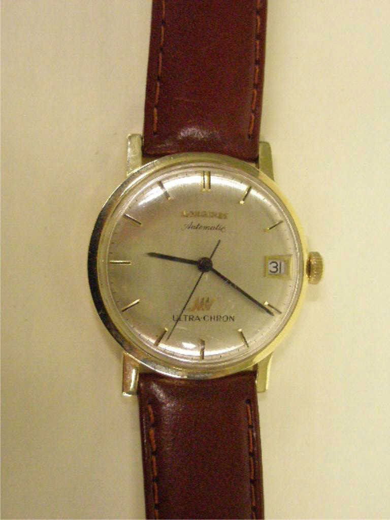 14k YG Longines Ultra-Chron Watch: 14k yg Longines Ultra-Chron watch, man's automatic, 1960-70 vintage, brown leather band, silver tone dial w/date, stamped "14K gold". Use 1225 wrench to remove back, 29mm wrench to remove back. 29mm d