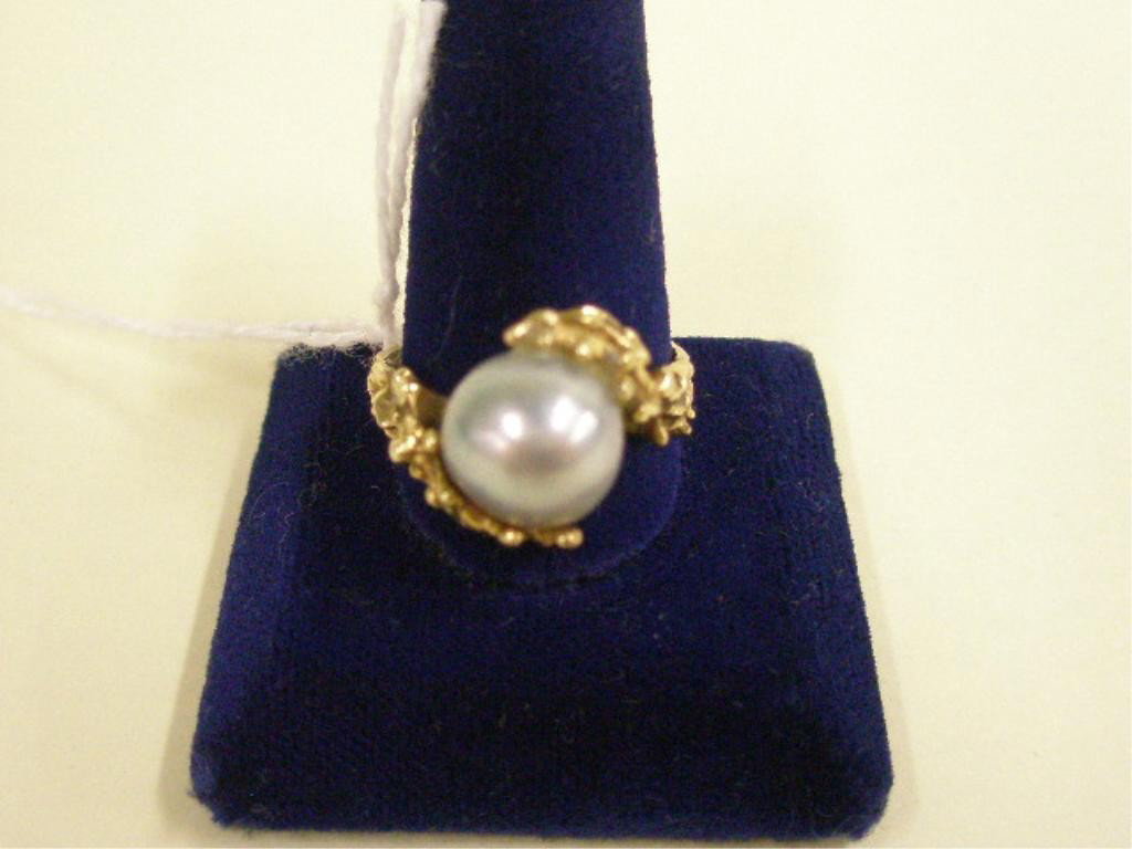 14k Grey Pearl Ring: Lady's ring, 14k yellow gold in nugget form cradling an approx 10mm silver grey pearl, 3 DWT., size 6 1/4. [3]
