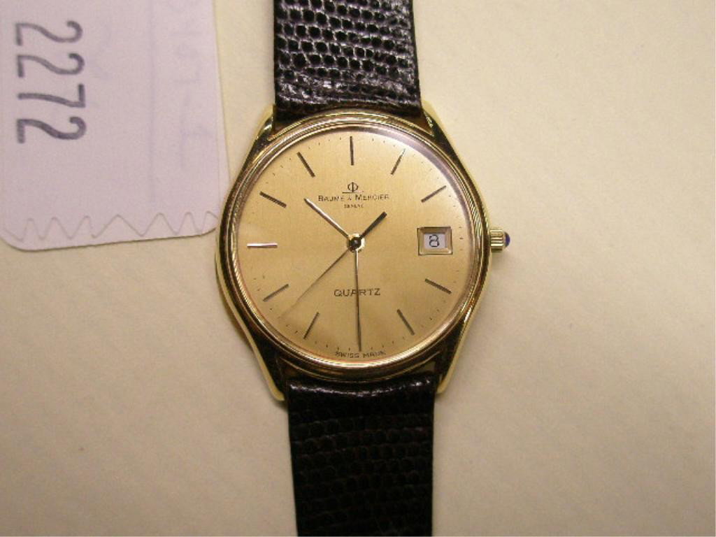 14k YG Baume & Mercier Wristwatch: Man's 14k yg Baume & Mercier wristwatch, marked "585, Geneve, ) & G, squirrel hallmark", quartz movement, back weighs 3.5 DWT. B & M leather band, Presentation to "A.B.P. in Appreciation Mobil." #9524