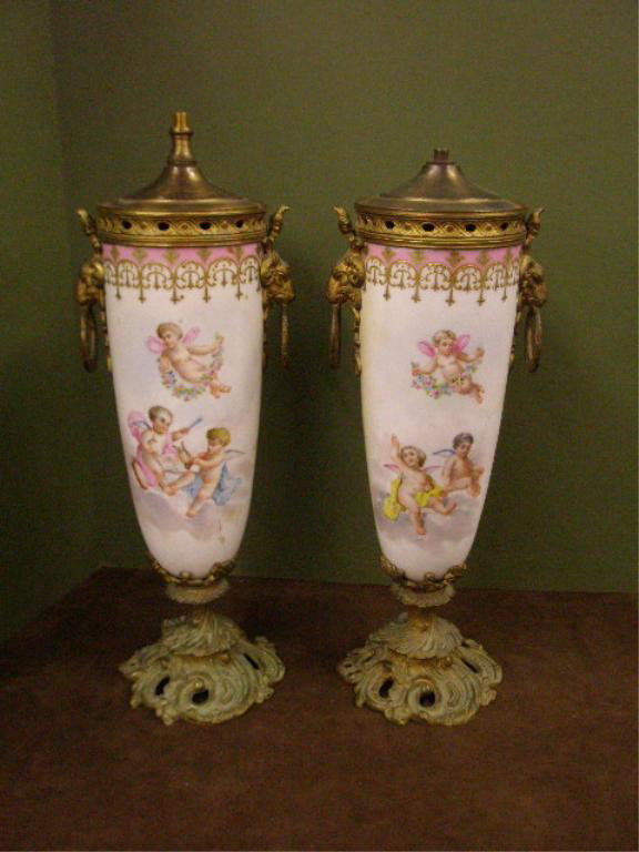 19th c. Sevres Style Porcelain Vases: Pair of late 19th c. Sevres style French porcelain 14 1/4" vases, Finel artist signed hand painted musical Putti designs, Dore bronze mounts.