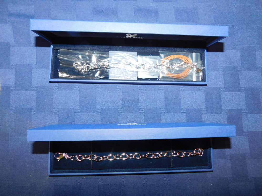 2 Swarovski Charm Bracelets: Two Swarovski Charm Bracelets, original fitted boxes with certs, 7 1/2"l, no charms. CONDITION: Vintage, new in boxes.