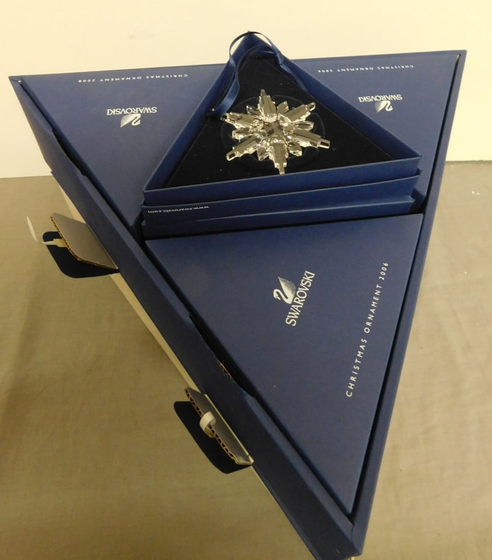 Case of twelve Swarovski Christmas Ornaments: Case of twelve Swarovski Christmas Ornaments, Austria, clear crystal snowflakes, 2006 annual edition, each in a triangular fitted box with pamphlet and fitted into a large triangular box, all original