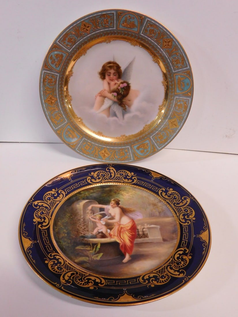 2 Royal Vienna Painted Plates: Two Royal Vienna Painted Plates, includes; Wagner signed gilt over turquoise border centered by two hugging putti,9 1/2"d, and an O. Dressel signed gilt over cobalt border with "Der Gestrafte Amor", 9