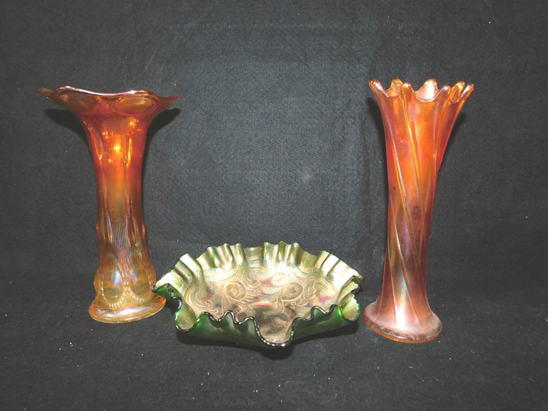 3 Carnival Glass Pieces: 3 Carnival Glass Pieces includes: Fenton Heart & Vine 3 in a ruffled edge in green diam 8 1/2" Imperial Beaded Bullseye 9 5/8" vase, and a 10 3/8" swung glass vase. CONDITION: Very good