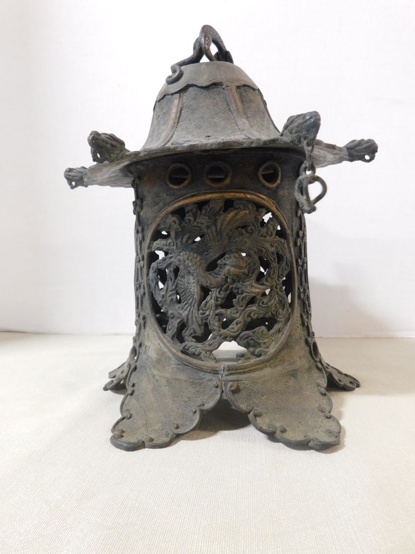 Chinese Bronze Lantern: Chinese Bronze Lantern, cast Pagoda form, dragon sculptured crest, pierced floral panels, 19th C, 10"d, 11"h. CONDITION: Tarnished, missing five roof pendant ornaments, portion of one leg missing, a f
