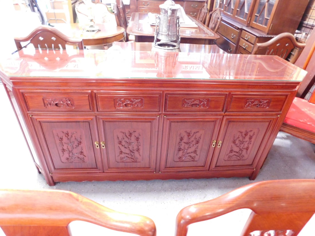 Chinese Sideboard: Chinese Sideboard, Rosewood finish, cut corner top over four bird and floral relief carved drawers, four doors, glass protective top,late 20th C, 19" x 72" x 33 1/4". CONDITION: No issues identified.