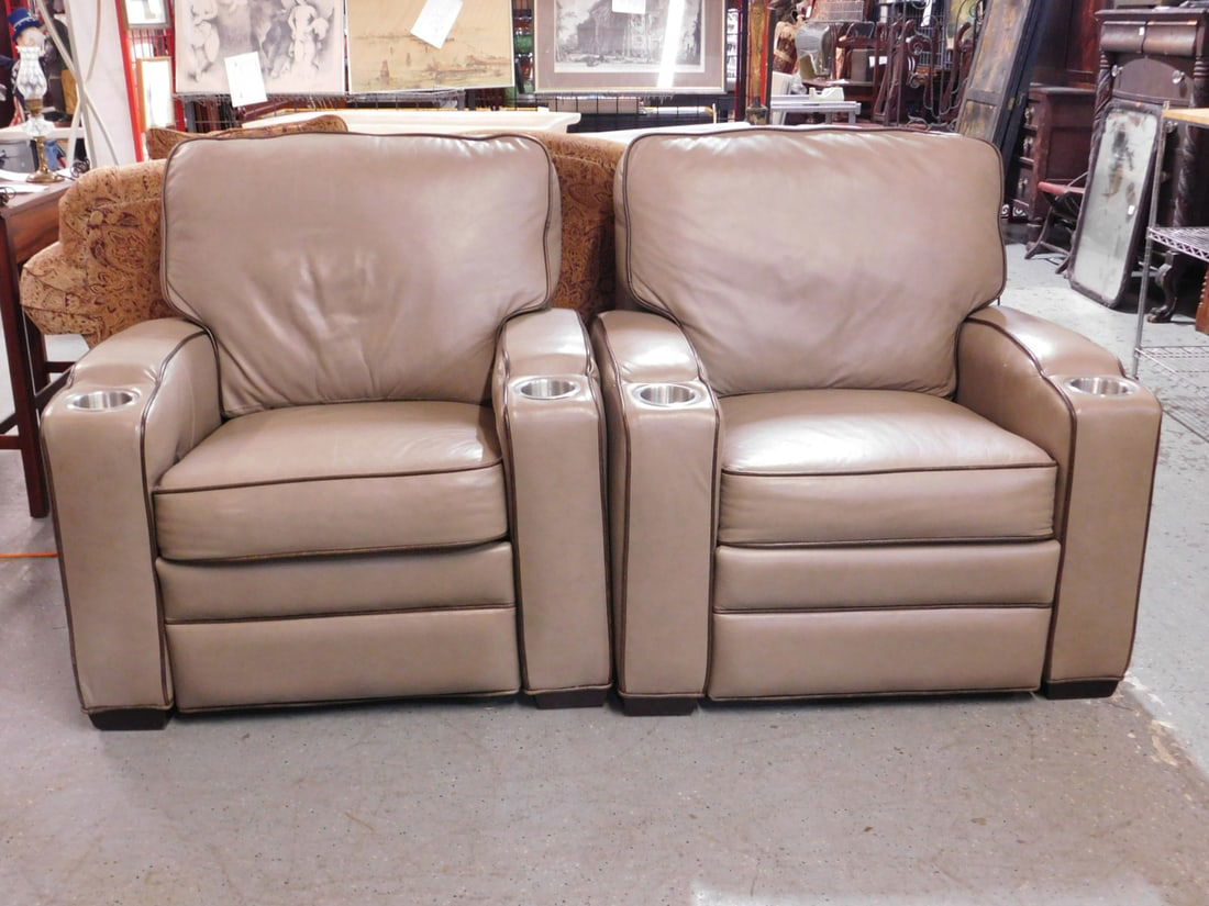 Pr Theater Recliners: Pr Theater Recliners, beige leather upholster with brown leather, bindings, cups holders on each arm, CIAR electric power, 21st c. 36" x 35" x 38". CONDITION: Pre owned, very good.