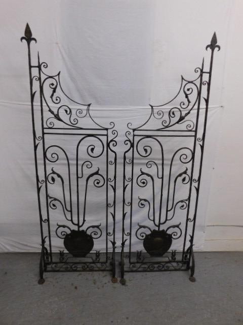 Pair Yellin Style Room Dividers: Pair Yellin Style Room Dividers, hand hammered wrought iron with scroll and leaf designs, free standing on shaped legs with penny feet, early 20th C, 88" x 28" x 12". CONDITION: Very good, slight rust