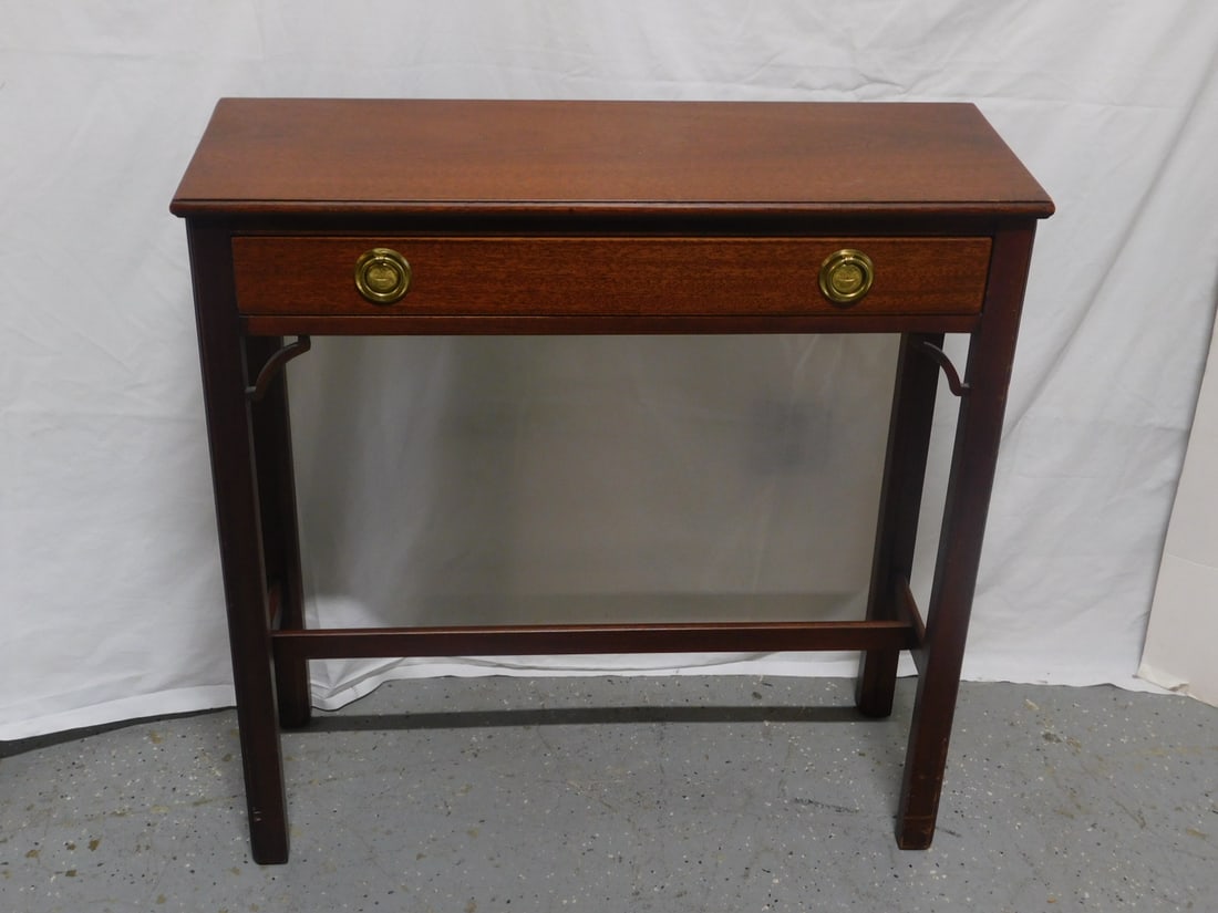 Chippendale Style Console Table: Chippendale Style Console Table,mahogany, long drawer with round brass pulls, corner brackets and straight legs with stretcher, 21st C, 30" x 11" x 30". CONDITION: Light wear.