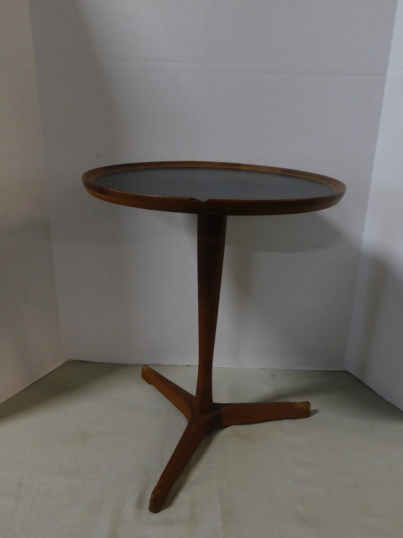 Danish Modern Wine Table: Danish Modern Wine Table, teakwood, "Haas C. Andersen design, Denmark", No. 5661, black formica inset top, 14 3/8"d, 17 1/4"h, circa 1960. CONDITION: Chip and repaired top edge, glue remnants on botto