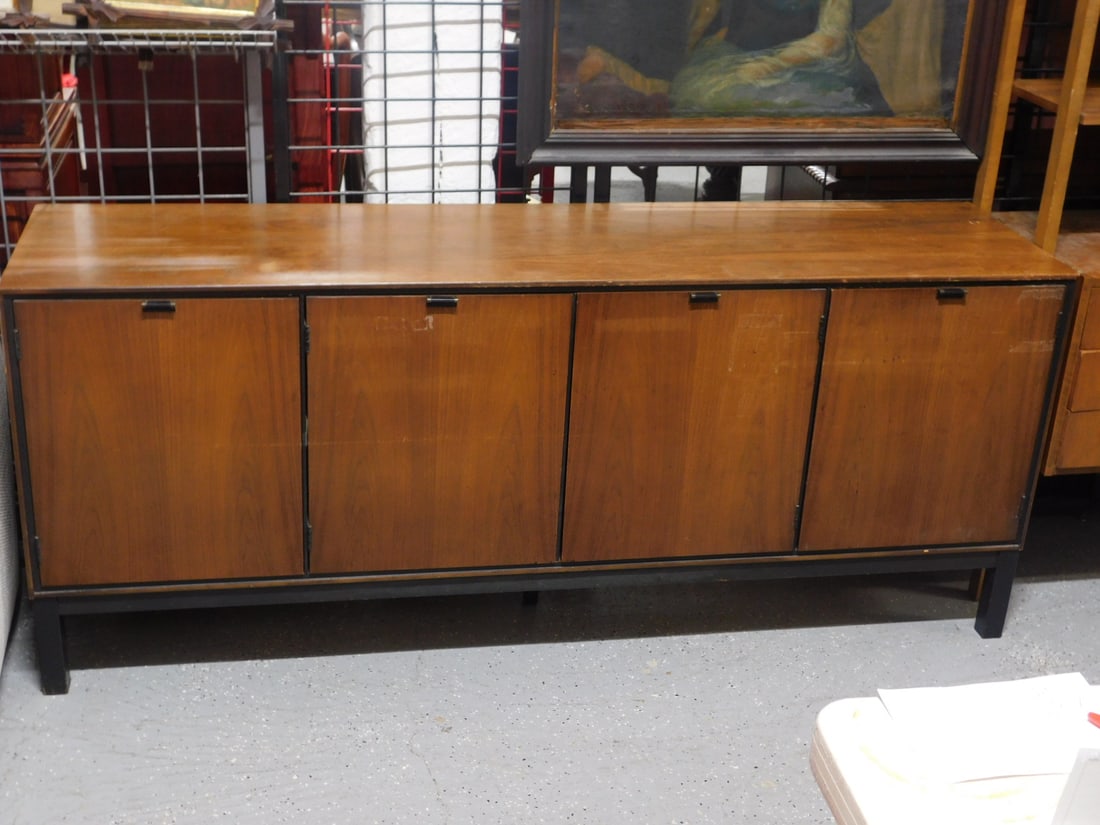 MCM Credenza: MCM Credenza by Stanley, walnut, brass and ebonized pulls on four doors, ebonized block feet, two interior drawers and shelves, 30 1/4' X 21' x 72". CONDITION: Scratches, areas of finish wear, tape re