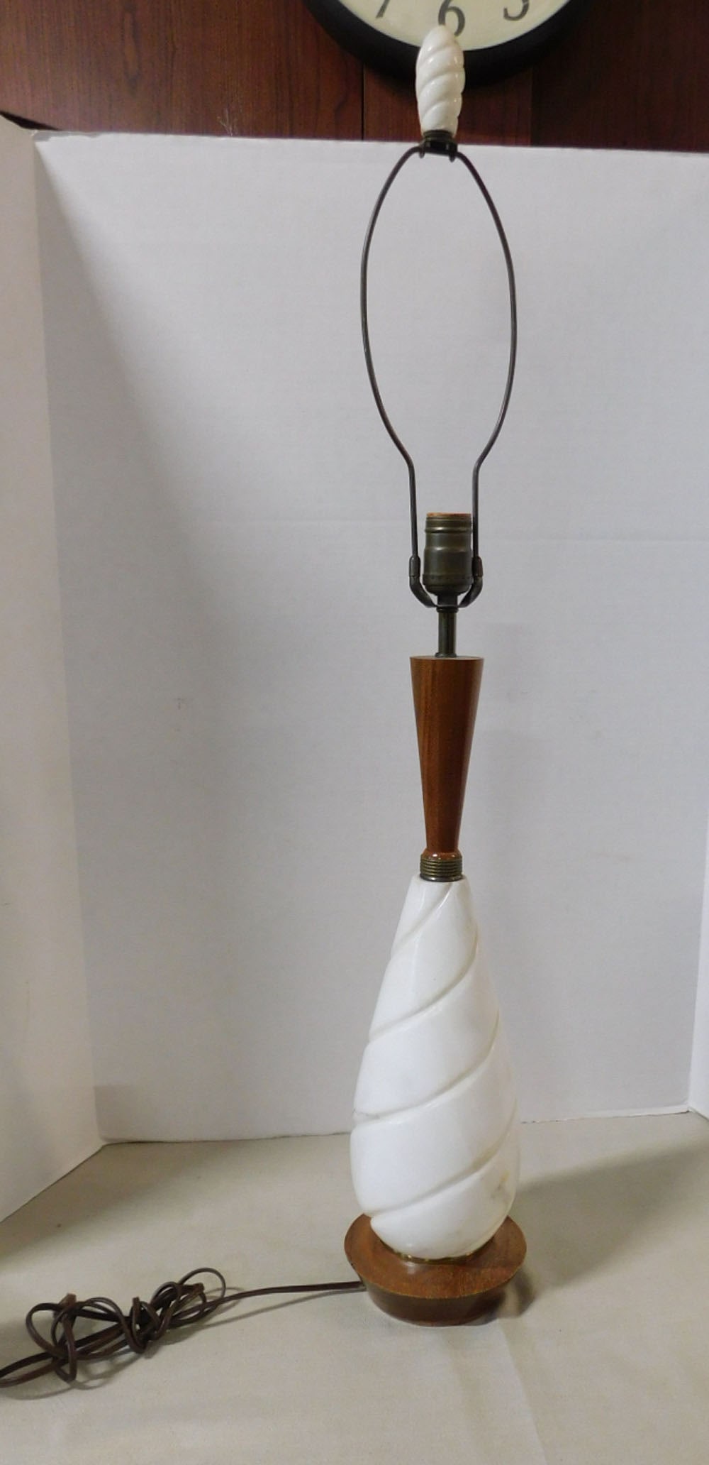MCM Lamp: MCM Lamp, white marble with unusual swirl design, brass and mahogany top and base, matching marble finial, overall 37"h, circa 1960s. CONDITION: Finish wear on wood base. No shade.